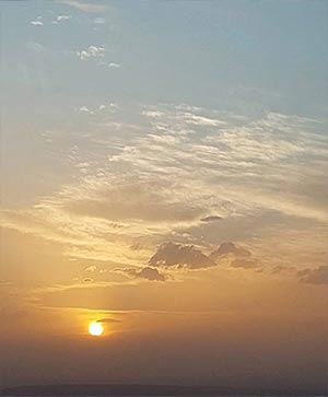 غروب خورشید در آسمان نیمه‌ابری – آرامش پایان روز در دل طبیعت